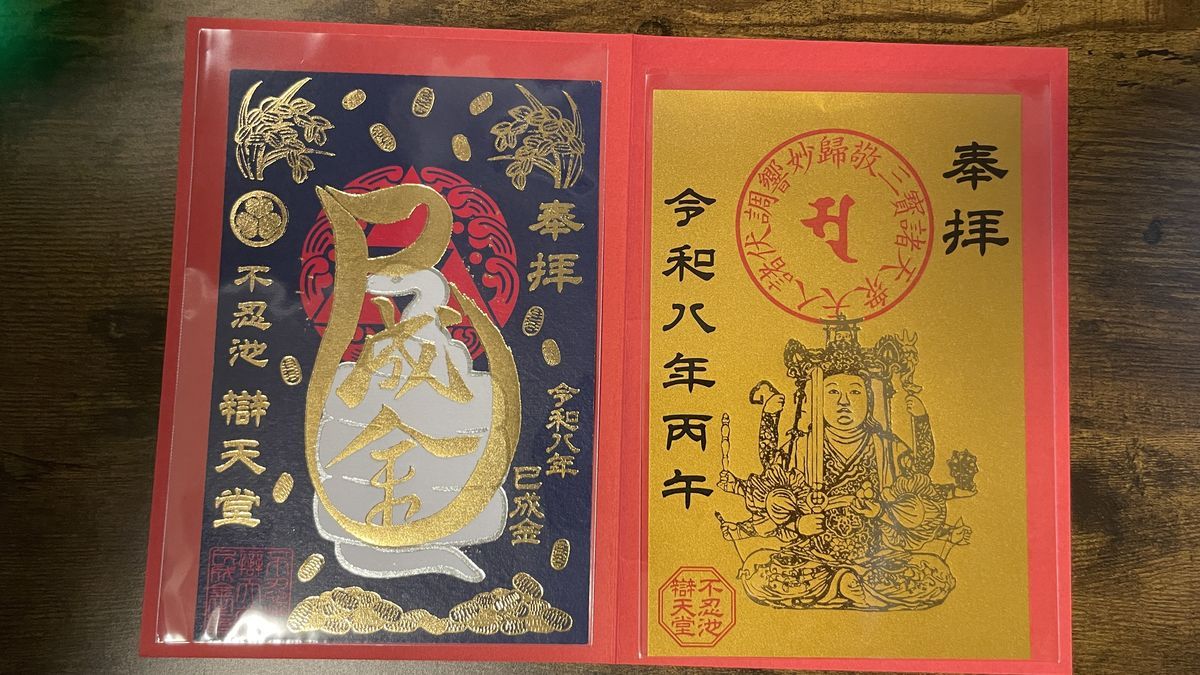 不忍池辯天堂の巳成金大祭の限定の特別御朱印。紺色の紙に金色の「巳成金」の字、金色の紙にたくさんの腕を持つ仏さまの絵